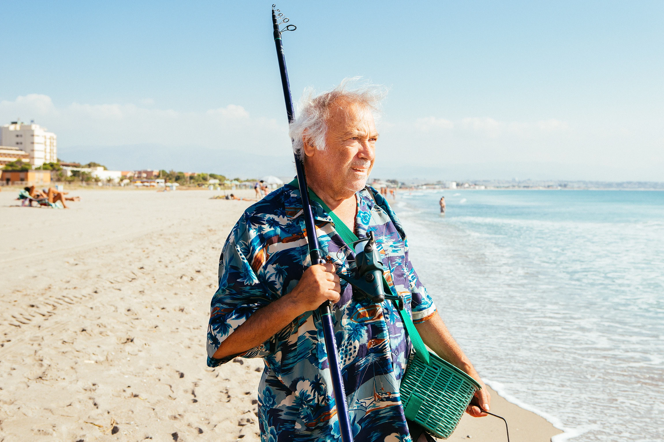 Man fishing at the beach, representing men’s health and minimally invasive prostate artery embolization care at Third Coast Vascular.